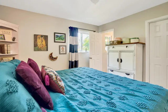 a bedroom with a bed and a dresser