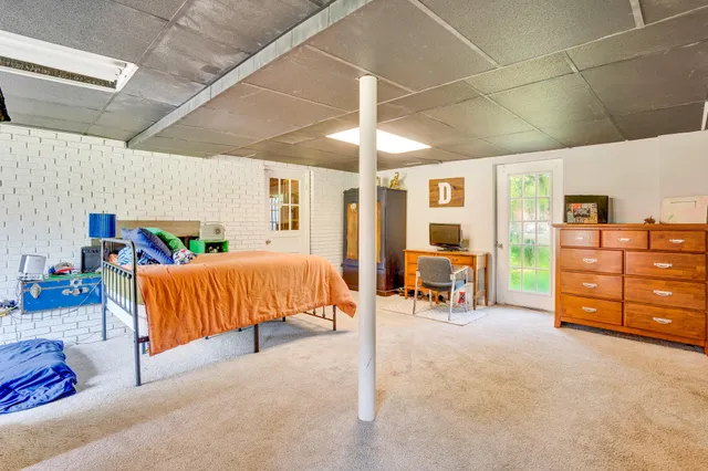 a bedroom with furniture and a lamp