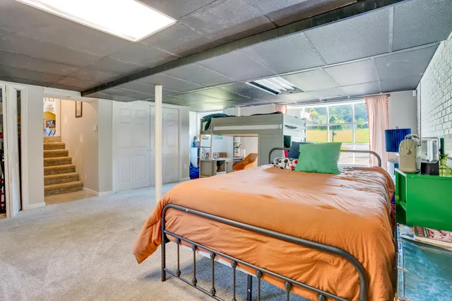 a bed room with a bed and a large window