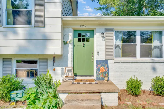 front view of house with potted plants