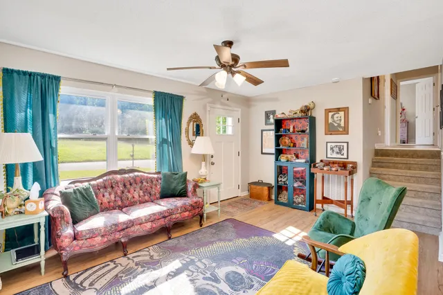 a living room with furniture and a large window