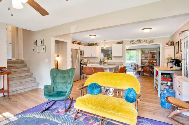 a living room with furniture and a dining table
