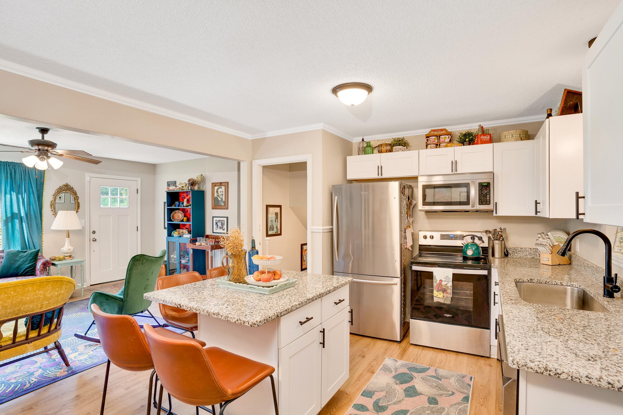 5961 Congress Lane Harrison, TN 37341 - Photo 10 of 30 a kitchen with stainless steel appliances kitchen island granite countertop a refrigerator a stove top oven and a dining table with wooden floor