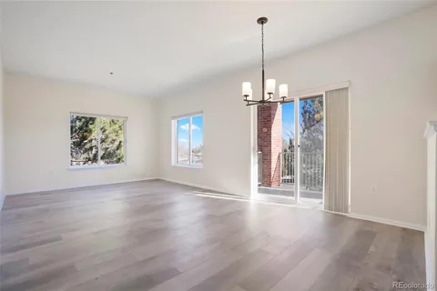 a view of a room with window and wooden floor