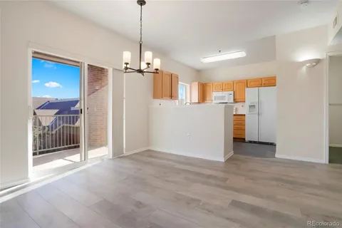 a view of a kitchen with a refrigerator and a sink