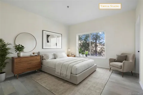 a bedroom with a bed couch and window