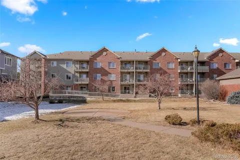 an aerial view of residential houses with outdoor space and seating