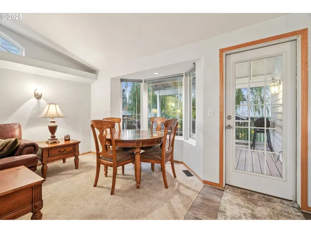 a dining room with furniture and window