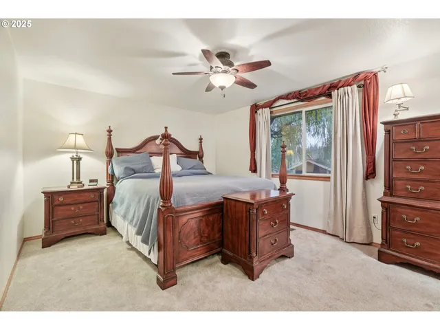 a bedroom with a bed dresser and a window