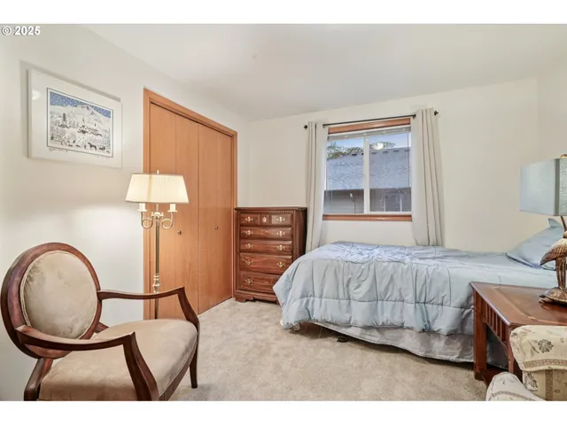 a living room with a bed furniture and a window