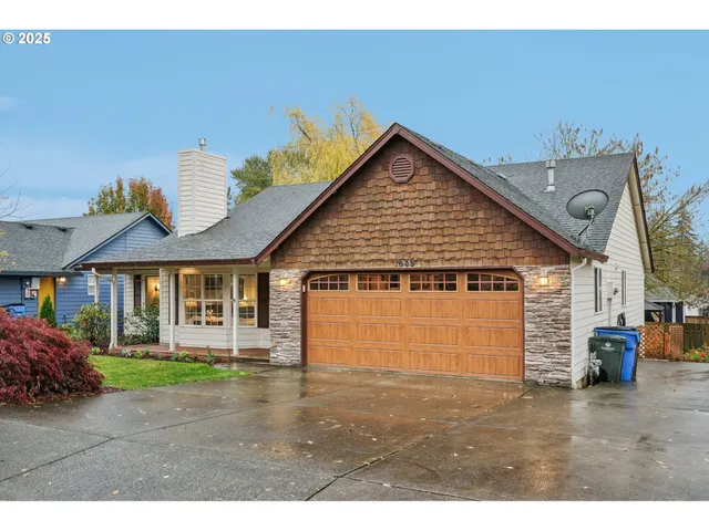 a view of a big house with a yard and potted plants