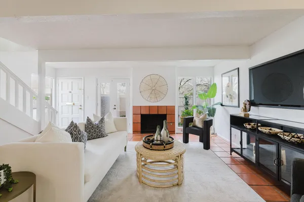 a living room with furniture a fireplace and a flat screen tv