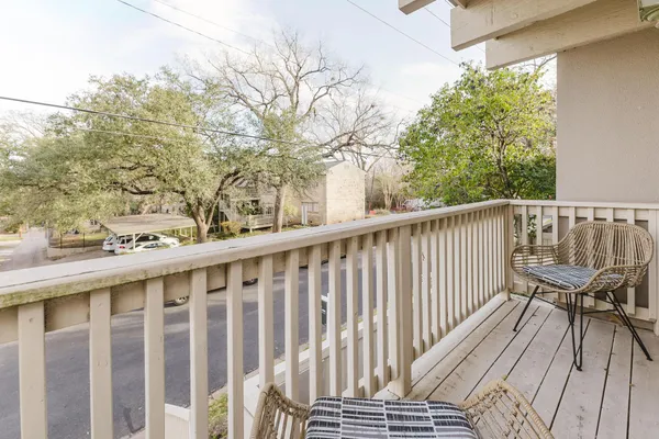 a view of a roof deck with wooden floor and fence