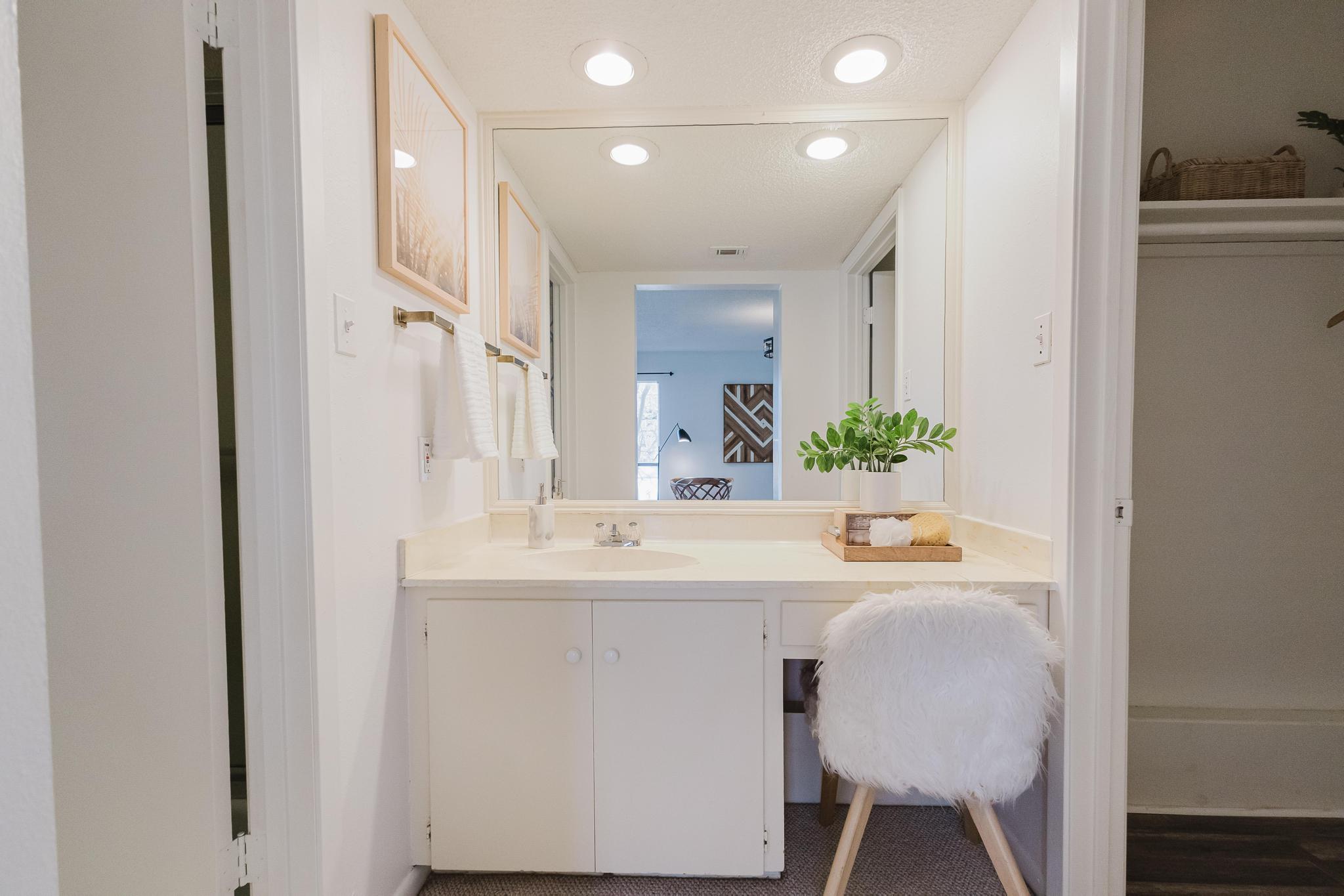 3500 Enfield Road, Unit F Austin, TX 78703 - Photo 17 of 22 a bathroom with a sink and a mirror