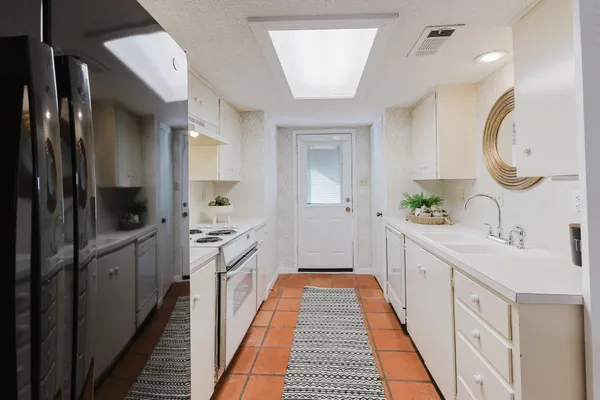 a spacious bathroom with a double vanity sink and a mirror