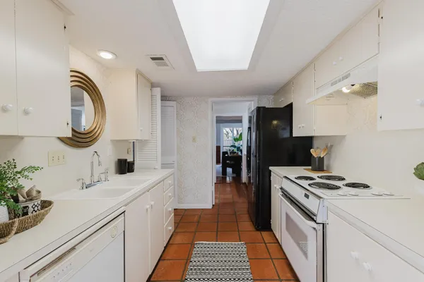 a kitchen with a sink cabinets and appliances
