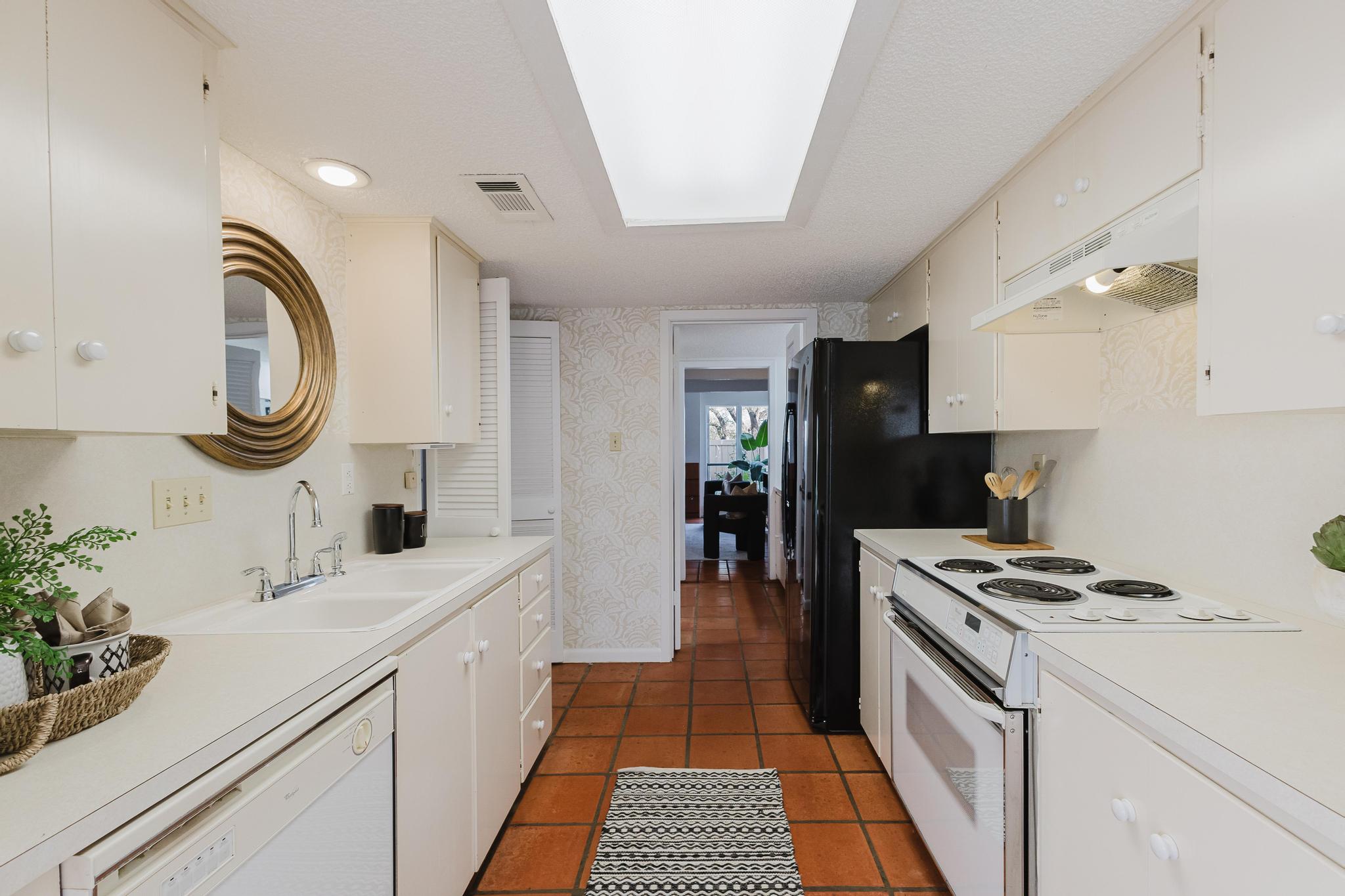 3500 Enfield Road, Unit F Austin, TX 78703 - Photo 8 of 22 a kitchen with a sink cabinets and appliances