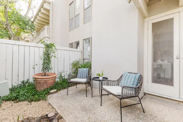 a view of a chair and table in backyard