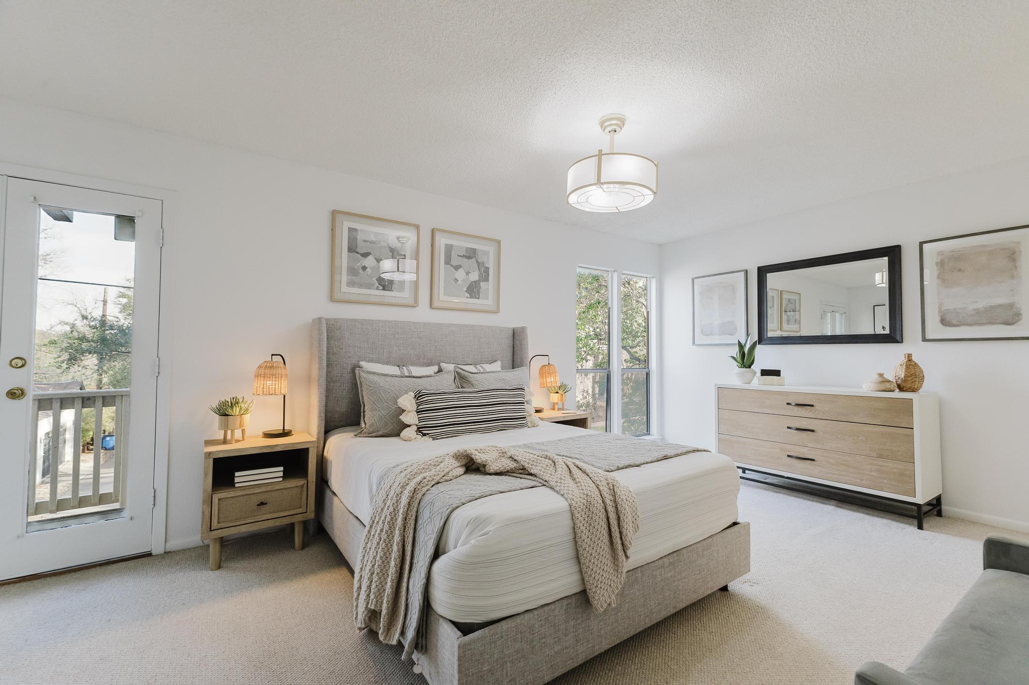 3500 Enfield Road, Unit F Austin, TX 78703 - Photo 10 of 22 a bedroom with a bed a chandelier and a dresser