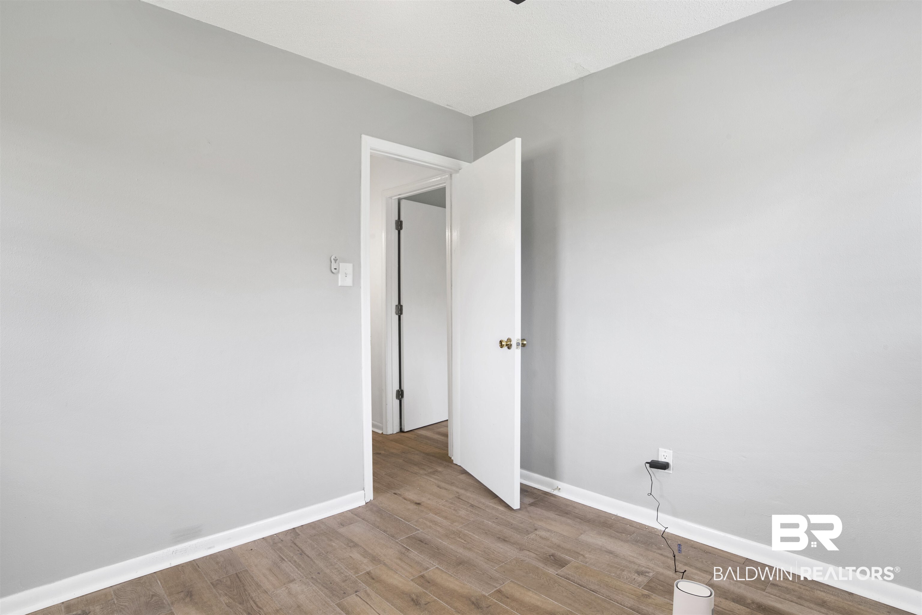 10244 Magnolia Road Irvington, AL 36544 - Photo 15 of 37 Spare room featuring baseboards and wood finished floors