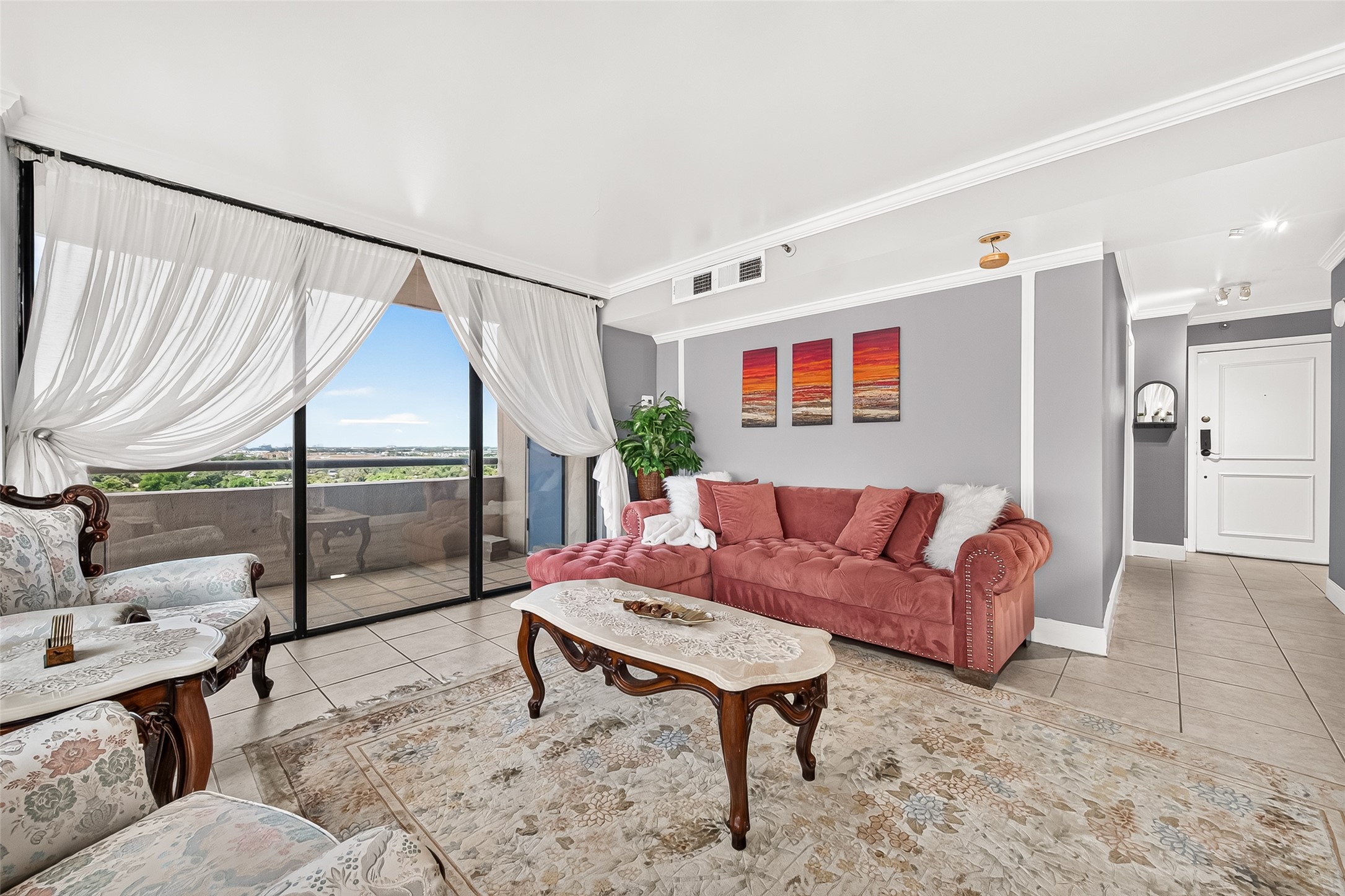 3525 Sage Road, Unit 1116 Houston, TX 77056 - Photo 8 of 25 Bright living room with tiled flooring, crown molding, and panoramic views.