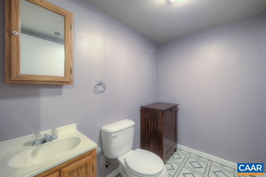 59 Narcissus Road Ruckersville, VA 22968 - Photo 21 of 35 a white toilet sitting next to a bathroom sink