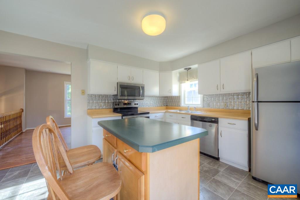 59 Narcissus Road Ruckersville, VA 22968 - Photo 7 of 35 a kitchen with stainless steel appliances granite countertop a sink stove refrigerator and microwave
