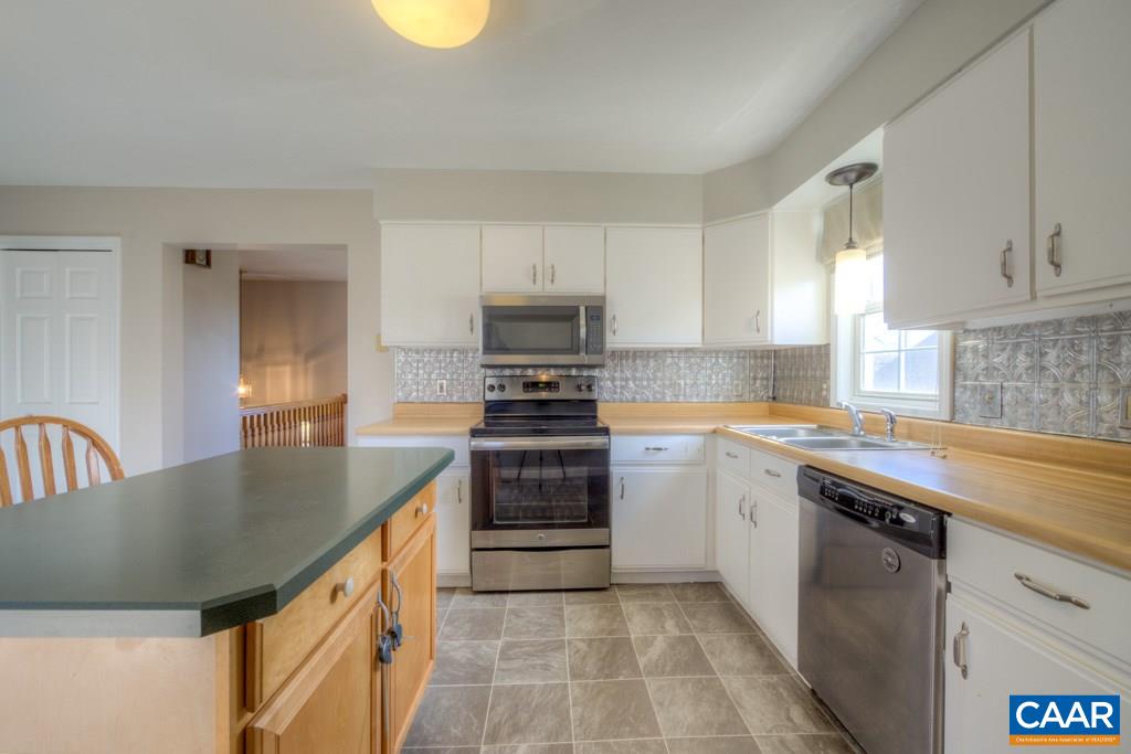 59 Narcissus Road Ruckersville, VA 22968 - Photo 8 of 35 a kitchen with granite countertop a sink a stove and cabinets