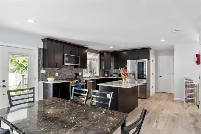 a view of a dining room kitchen with furniture and a wooden floor