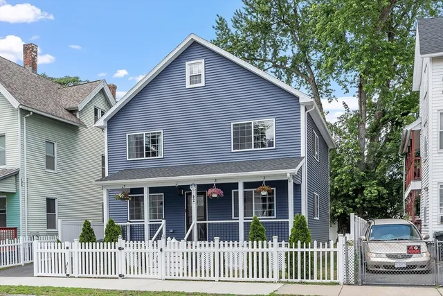 a front view of a house with a garden