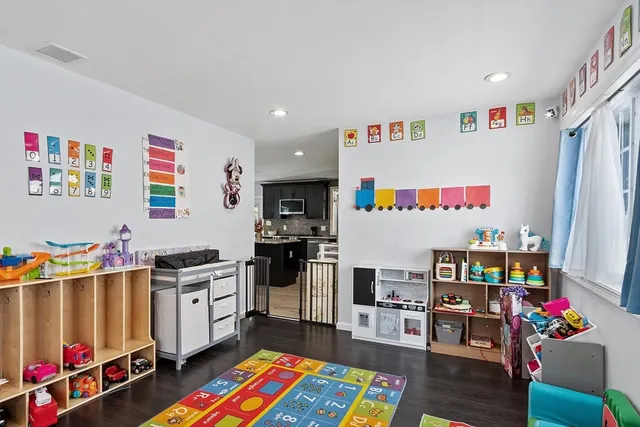a living room with furniture a baby crib and a couch