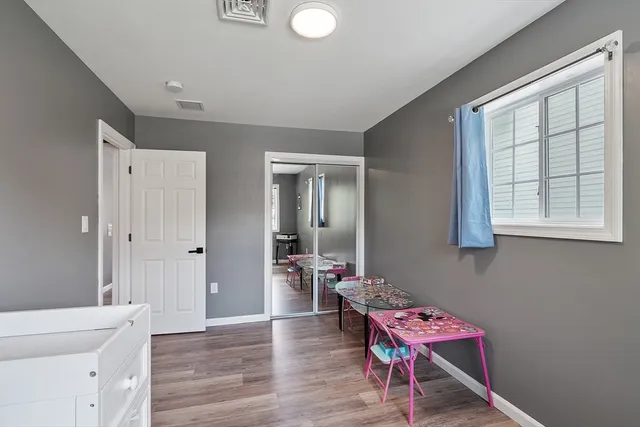 a hallway with furniture and wooden floor