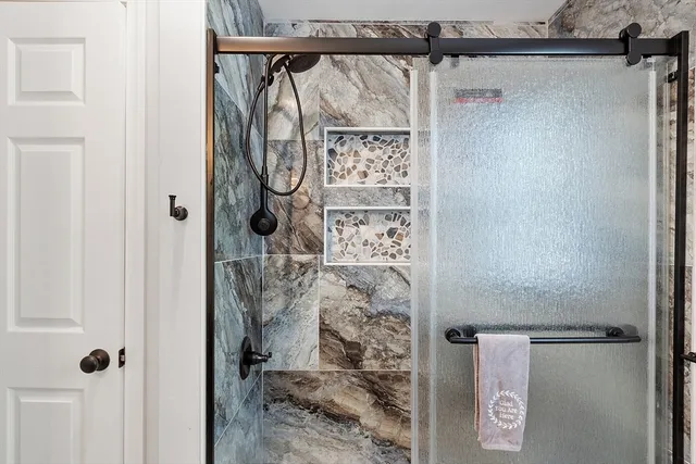 a bathroom with a glass shower door