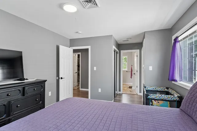 a bedroom with a bed and a flat screen television