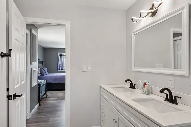 a en suite bathroom with a sink and mirror