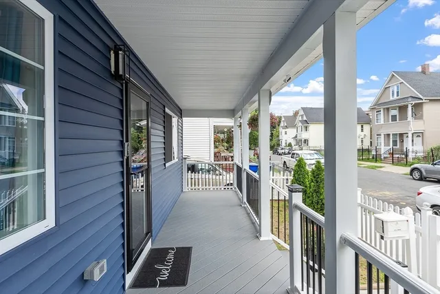 a view of a porch with wooden floor and stairs