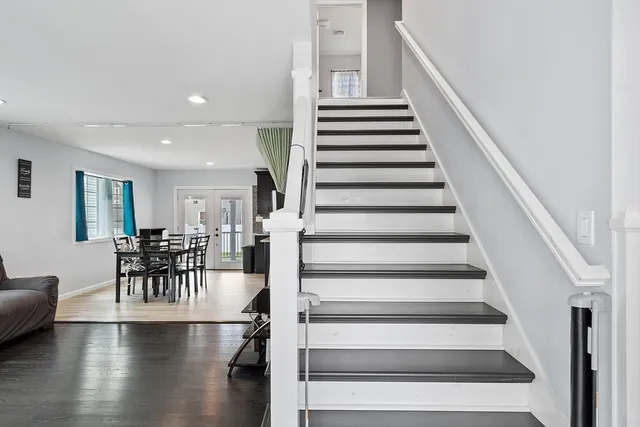 a view of entryway and hall with wooden floor