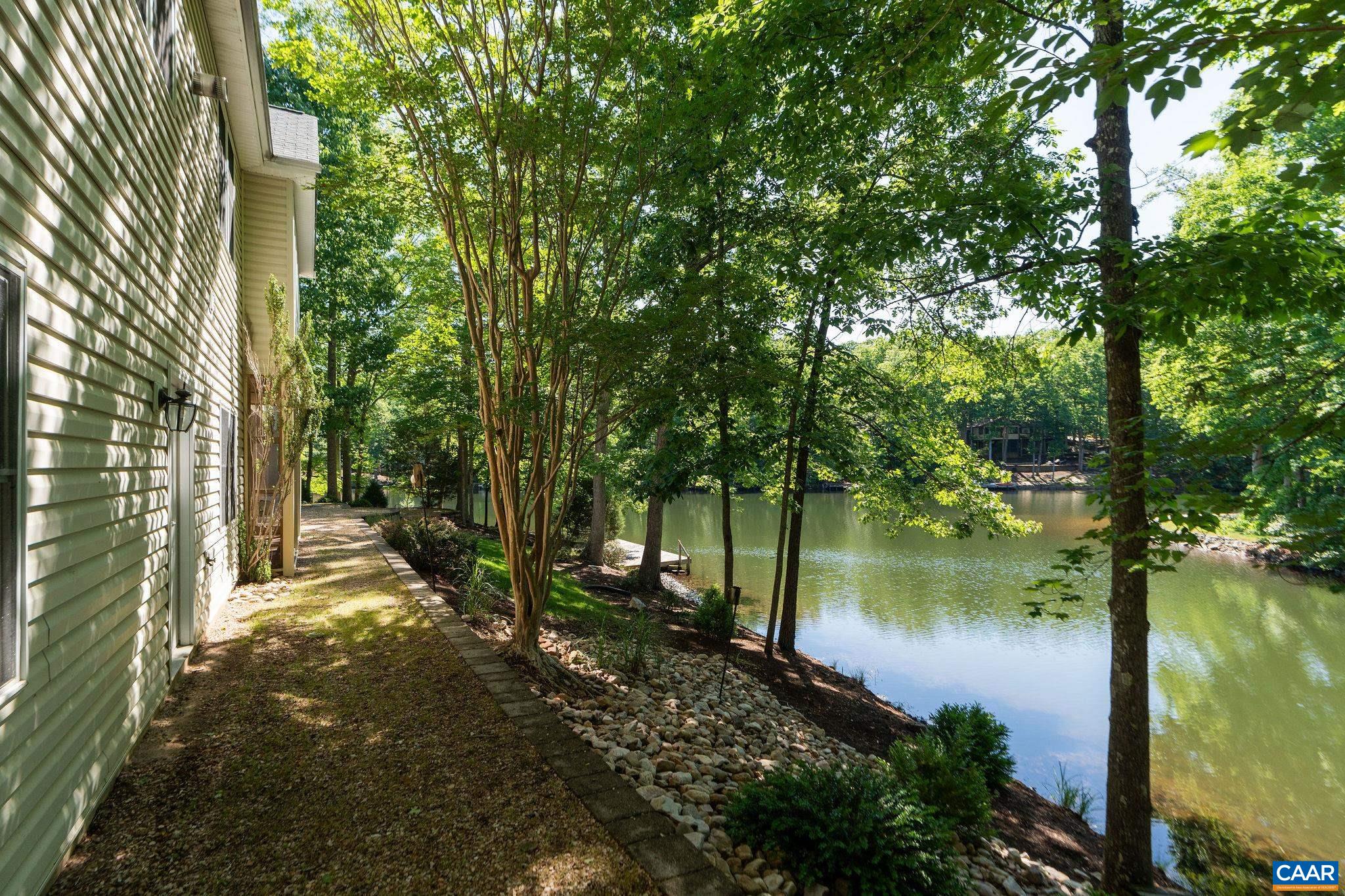 21 Amethyst Road Palmyra, VA 22963 - Photo 63 of 66 a backyard of a house with lots of green space and lake view