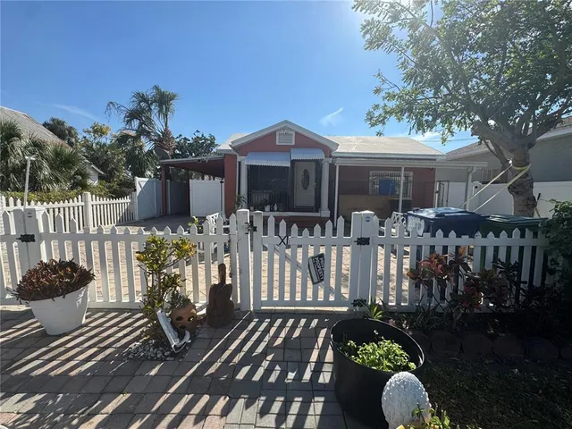 a view of a house with wooden deck and furniture