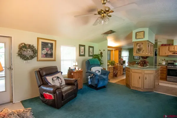 a living room with furniture and a chandelier