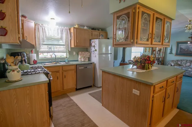 a kitchen with stainless steel appliances granite countertop a sink stove and cabinets