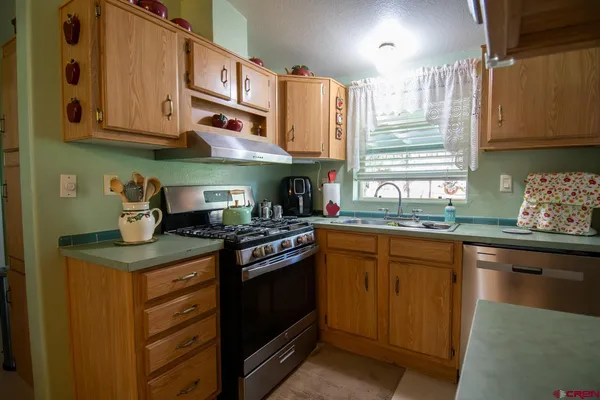 a kitchen with stainless steel appliances granite countertop a stove and a sink
