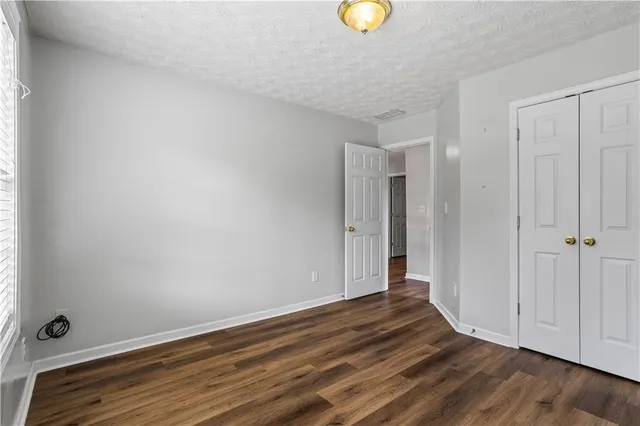a view of an empty room and wooden floor