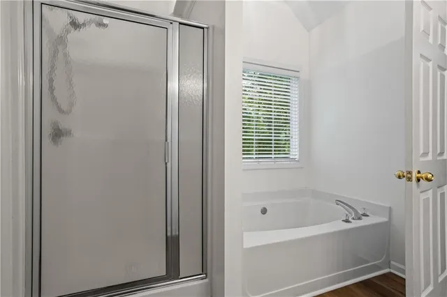 a bathroom with a bathtub and a shower
