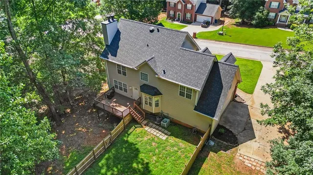 an aerial view of a house with garden space and street view