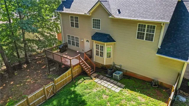 a aerial view of a house with a yard and furniture