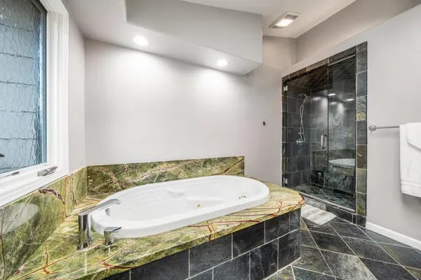 a bathroom with a tub and shower