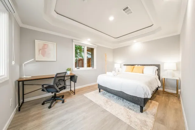 a bedroom with a bed a desk and chair