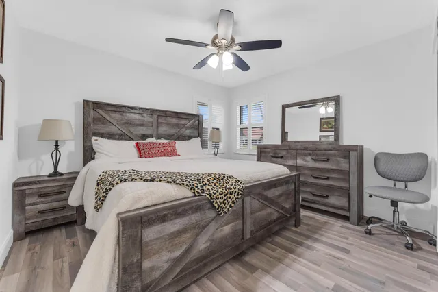 a bedroom with a bed and a chandelier