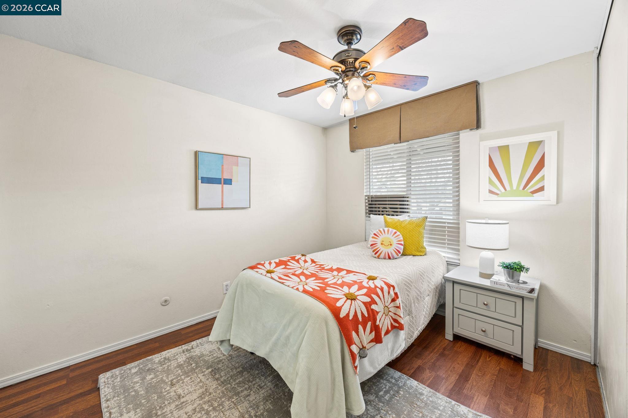 2069 Olivera Road, Unit E Concord, CA 94520 - Photo 11 of 18 a bedroom with a bed and wooden floor